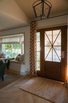 a living room filled with furniture and a wooden door