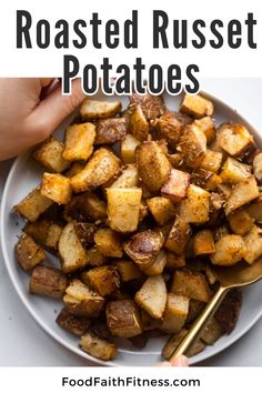 roasted potatoes on a white plate with gold spoons and text overlay that reads roastedrusset potatoes