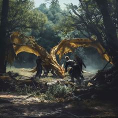 some people are walking through the woods with large yellow dragon wings on their back and two men riding horses behind them