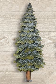 a ceramic christmas tree sitting on top of a wooden table