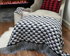 a living room with a couch and fireplace in it's center area, including a blanket on the floor