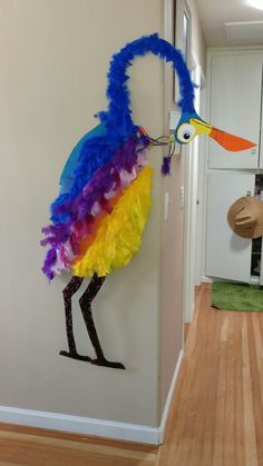 a colorful bird is hanging on the wall