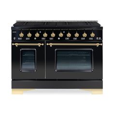 a black stove top oven with gold trimmings and two burners on each side