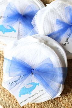 three baby diapers with blue bows on them