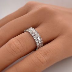 a woman's hand with a diamond ring on it