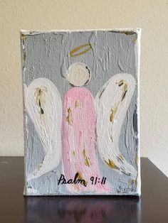 an angel painting on a wooden block