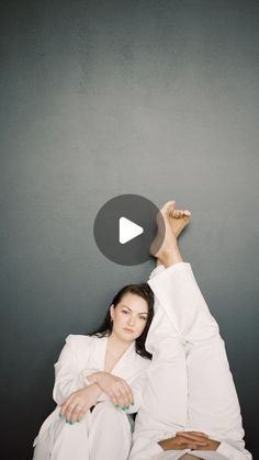 a woman laying on top of a bed with her arms up