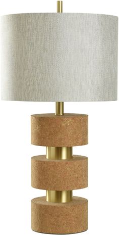 a table lamp with a white shade on top and gold trim around the lamps base