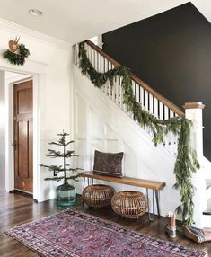 a wooden bench sitting under a banister next to a stair case covered in greenery