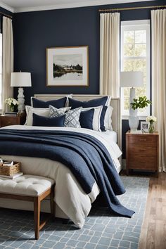 a bedroom with blue walls and white bedding in the center, along with two windows