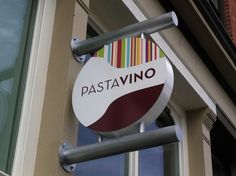 a sign on the side of a building that says pastavino in italian and english