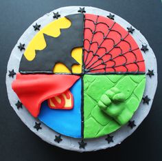 a cake decorated to look like batman, spiderman and green lantern