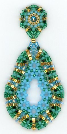 a green and blue beaded brooch with gold trimmings on white background