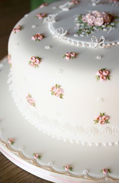 a white cake with pink flowers on it