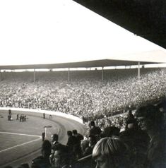 an old black and white photo of a crowd at a baseball game in the stadium