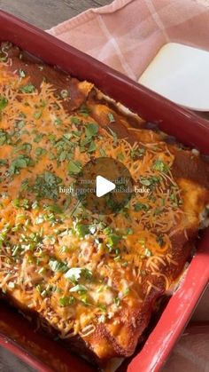 a red casserole dish with cheese and green garnish