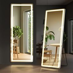 a large mirror sitting on top of a wooden floor next to a table and chair