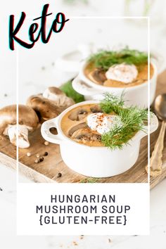 two white bowls filled with mushroom soup on top of a wooden cutting board next to mushrooms