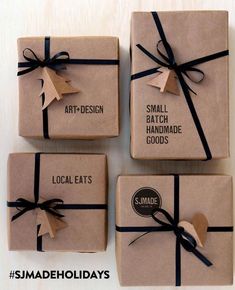 four wrapped gift boxes with brown paper and black ribbon