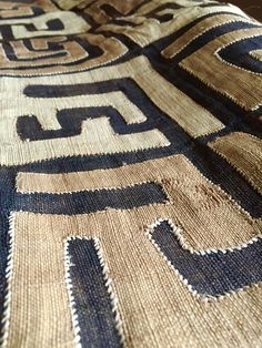 an old rug with blue and brown designs on it