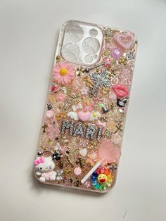 an iphone case that has many different things on the back and sides, including flowers