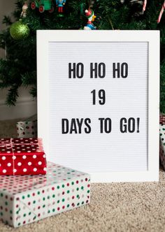 a sign that says ho ho 19 days to go next to presents under a christmas tree