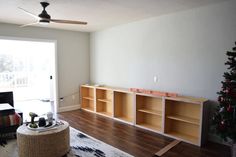 a living room filled with furniture and a christmas tree