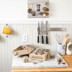 the kitchen counter is cluttered with spices and utensils, including an assortment of knives