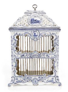 a blue and white birdcage with two birds in it