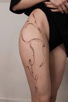 a woman's thigh with a tattoo on it and her legs crossed in the shape of a horse