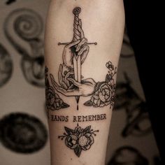 a person with a tattoo on their arm that reads hands remember and has an anchor in it