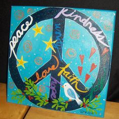 a peace sign painted on top of a wooden table