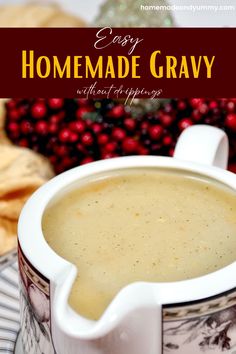 a bowl of homemade gravy with cranberries and bread in the background