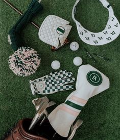 golf accessories laid out on the grass with gloves, balls and tees next to them