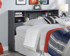 a bedroom with a bed, nightstand and pictures on the wall