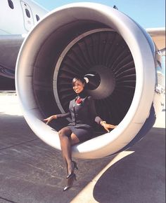 a woman sitting in the middle of an airplane engine