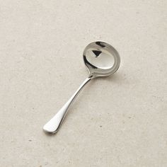 a metal spoon with an arrow on it