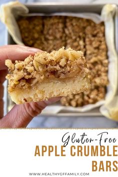 a hand holding an apple crumble bars with the text gluten - free apple crumble bars