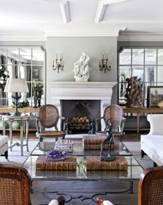 a living room filled with furniture and a fire place in the middle of a room