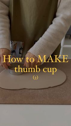 a person is making a cup on a table with the words how to make thimb cup