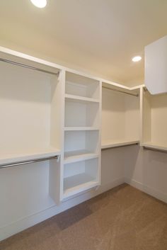 an empty white closet with no one in it or someone else to use the space