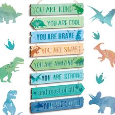 wooden sign with dinosaurs and words hanging from it's sides in front of a white background