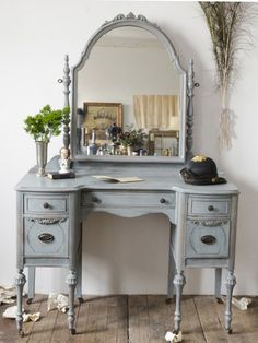 an old vanity with a mirror and flowers on it