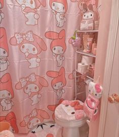 a pink bathroom with hello kitty shower curtain