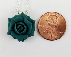 A handcrafted teal rose necklace, This little teal flower necklace drops from a hand wired bail and from a cable chain. This little green rose pendant is great for bridesmaid jewelry with a green wedding theme or everyday wear. Other matching accessories available. -Original hand sculpted polymer clay flowers -Durable, water-resistant -No molds, no paint, no glue -Flower Size : Petite 1.5cm -Chain Length : Choose 16 or 18 inch -Components : Silver-plated, Gold-plated, Antique Brass, 925 sterling Green Jewelry Gift With Rose Design, Green Rose Design Jewelry For Gift, Green Jewelry With Rose Design For Gift, Black Rose Jewelry, Green Wedding Theme, Teal Bridesmaid, Rose Pendant Necklace, Dark Teal Green, Green Themed Wedding