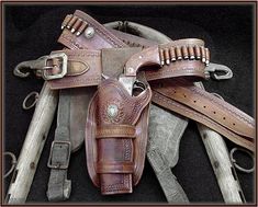 several different types of leather belts and knives