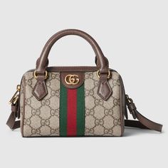 The Gucci Ophidia Super Mini Bag is crafted from beige and ebony GG Supreme canvas. The bag features a Double G hardware, a Web stripe, and a detachable shoulder strap. The interior is lined in cotton linen and features an internal keychain hook. It has leather top handles with a 1.8-inch drop and a shoulder strap with a 21.3-inch drop. The bag closes with a zip closure and measures 6.5 inches wide, 3.9 inches high, and 3.5 inches deep. It weighs approximately 0.7 pounds and is made in Italy. Gucci Super Mini Bag, Gucci Green Bag, Gucci Super Mini, Gucci Mini Bag, Keychain Hook, Red Web, Gucci Store, Gucci Mini, Gucci Handbag