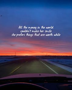 the sun is setting on an empty road with a quote written above it that reads, all the money in the world couldn't make her smile