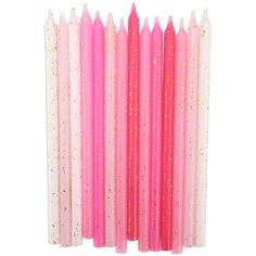 pink candles with gold glitter on them are lined up in a row against a white background