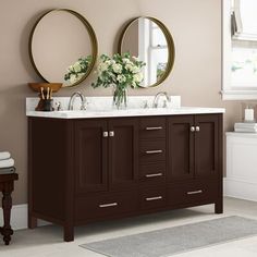 a bathroom with two sinks and mirrors on the wall